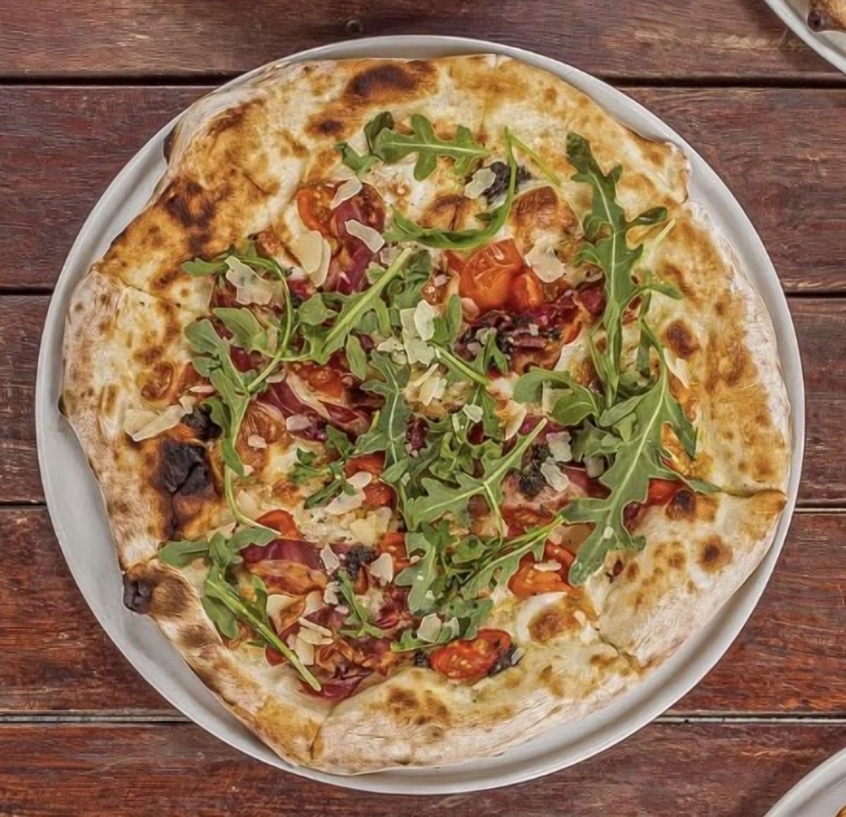 Pizza with rocket, cherry tomatoes and parmesan